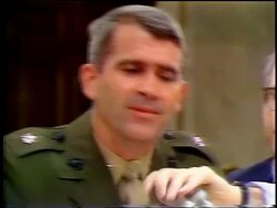 July, 1987 close up Oliver North laughs while listening to lawyer then talking during Iran-Contra hearings Stock Footage