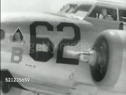 MOT 1939: NEW HEAVY BOMBERS: AERIAL Next to B-17 Bomber front fuselage (#62 w/ Devil caricature holding bomb in hand), MS #51 in flight, **VS Inside B-17, pilot using  hand-set, bomb bay doors slowly opening, XWS B-17 Bomber in distance dropping bombs Instructional Video