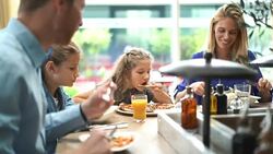Family having lunch at a restaurant. Stock Footage