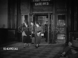 1953: UNION STATION: OMAHA, NEBRASKA: VS Passengers walking out from 'Gate 03' in Union Passenger Terminal. VS Worker unloading luggage off locomotive train, passengers, including Westbrook Van Voorhis getting off train. NE Instructional Video