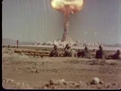 1950s MONTAGE POV Soldiers hiding inside trench / Soldiers standing up / PAN Atomic bomb exploding / Mushroom cloud forming and sending shockwaves at Camp Desert Rock at Nevada Test Site / Nye County, Nevada, USA Stock Footage