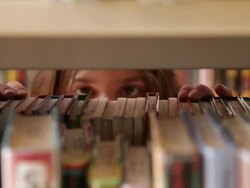 CU Girl picking book from bookshelf / Flagstaff, Arizona, USA Stock Footage