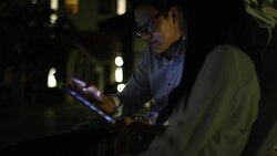 Married Couple search information for honeymoon tour from touch screen pc Stock Footage