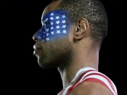 Serious looking man with US flag painted on face and shoulder Stock Footage