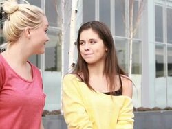 Female whispering in ear friend Stock Footage