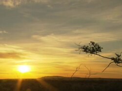 Wide Shot Timelapse - Sun rises over a flat, arid landscape / California USA Stock Footage