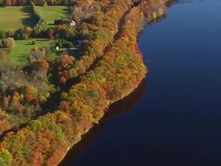 WS ARIEAL View of Wooded area and autumn color along Penobscot river / Maine, United States Stock Footage