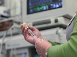Caucasian nurse loading syringe with medication Stock Footage