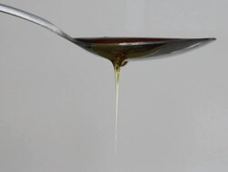 Honey dripping from spoon viscous Stock Footage