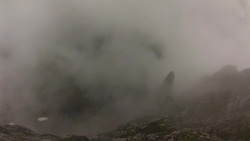POV wingsuit jumping off a cliff into dense clouds Stock Footage