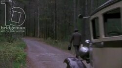 Car driving by a man in the countryside, 1930s - reenactment Stock Footage