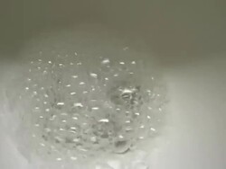 A white toilet flushes clear water. Stock Footage