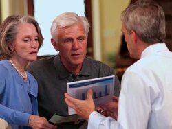 MS PAN Senior couple talking with financial planner in home living room / Richmond, Virginia, United Sates Stock Footage