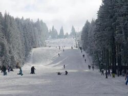WS View of skier and snowboarder on piste, winter sport and snow ski lift / Erbeskopf, Hunsruck, Rhineland Palatinate, Germany Stock Footage