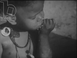 Moraccan village people preparing couscous and eating, a class of boys read the Quran, c.1960 Stock Footage
