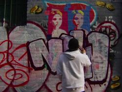 Wide Shot of Graffiti Artist Painting Urban Wall Stock Footage