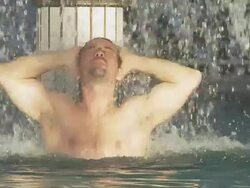 HD SLOW MOTION: Muscular Man Relaxing Under Spa Waterfall Stock Footage