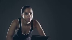 Female Athlete on training bike Stock Footage