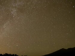 WS T/L  PAN ZO Milky Way moving across sky over icy peaks  / Flagstaff, Arizona, United States Stock Footage
