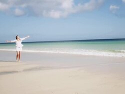 Woman spinning on beach Stock Footage
