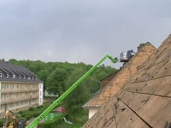 WS Housebreaker removing asphalt roof / Saarburg, Rhineland-Palatinate, Germany Stock Footage