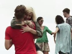 Young couple at a festival, man spinning woman round Stock Footage