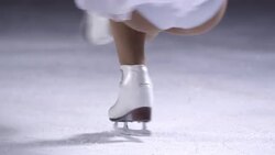 SLO MO Female figure skater doing a sit spin Stock Footage