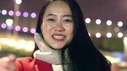 pretty asian girl taking photo with smart phone in modern city at night Stock Footage