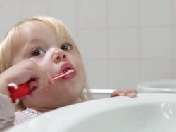 Young Girl In Bathroom Brushing Teeth Stock Footage