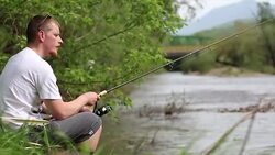 Young readhead man angling in admirable enviroment Stock Footage