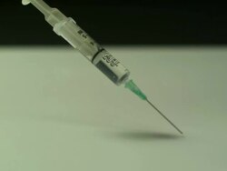 High speed Syringe falls on to surface Stock Footage