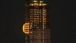 Full moon rises behind New York City buildings and construction. Stock Footage