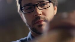 Young carpenter polishes smooth edge of handcrafted wooden board Stock Footage