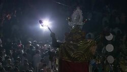 A bright spotlight illuminates a large goddess statue and spectators during India's Diwali celebration. Stock Footage