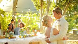 Bride and groom hugging and talking at wedding reception Stock Footage
