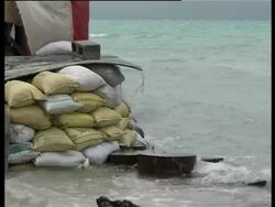 Waves lapping against sand bags, Kiribati, Central Pacific Stock Footage