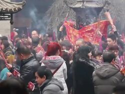 MS Pilgrims raising joss sticks to touch tintinnabulum of cense burner pray for good luck during Chinese Lunar New Year at Taoist temple / xi'an, shaanxi, china Stock Footage