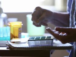 CU TD Elderly woman putting prescription medication in pill box / Minneapolis, Minnesota, United States Stock Footage