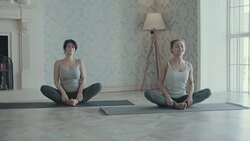 Two women doing yoga meditation and stretching exercises Stock Footage