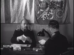 1940: VATICAN CITY: PONTIFICAL SWISS GUARDS: Unidentified officers talking in office (No SOT) w/ Swiss Guard banner hanging on wall BG, officer leaving room. Instructional Video