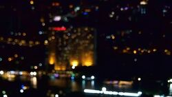 Bokeh of cityscape along river at night Stock Footage
