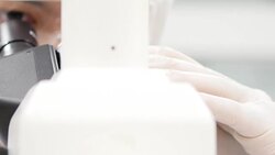 Scientist is using with microscope Stock Footage