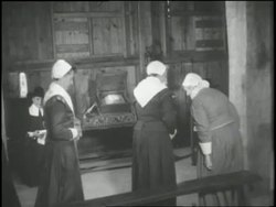 Pilgrims file into a church and a minister reads from the Bible in 1621. News Clip