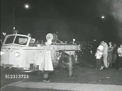 1951: FIREFIGHTERS: DRAMATIZATION: Fire truck at hydrant. TU Smoking window. Firemen w/ hose, others running BG, firefighter climbing into smoking window. Instructional Video