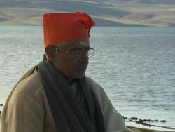 Block Shot Hindu Pandit praying at Mansarovar Lake Lhasa Tibet China Stock Footage
