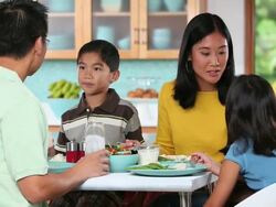 WS Family Eating Dinner Together in Kitchen / Richmond, Virginia, USA Stock Footage