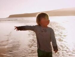 Child walking on beach Stock Footage