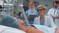 DS Female doctor checking up on woman lying in ICU Stock Footage
