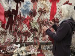 Woman looking at bow decorations Stock Footage