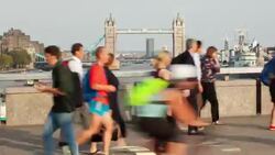 Timelapse of Commuters on London Bridge, with Tower Bridge in the background at rushour Stock Footage